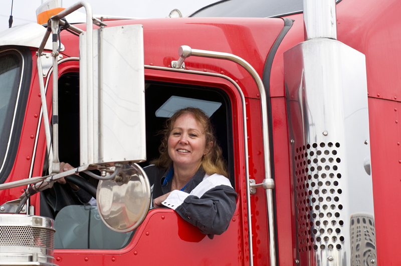 International Driver beside a semi truck
