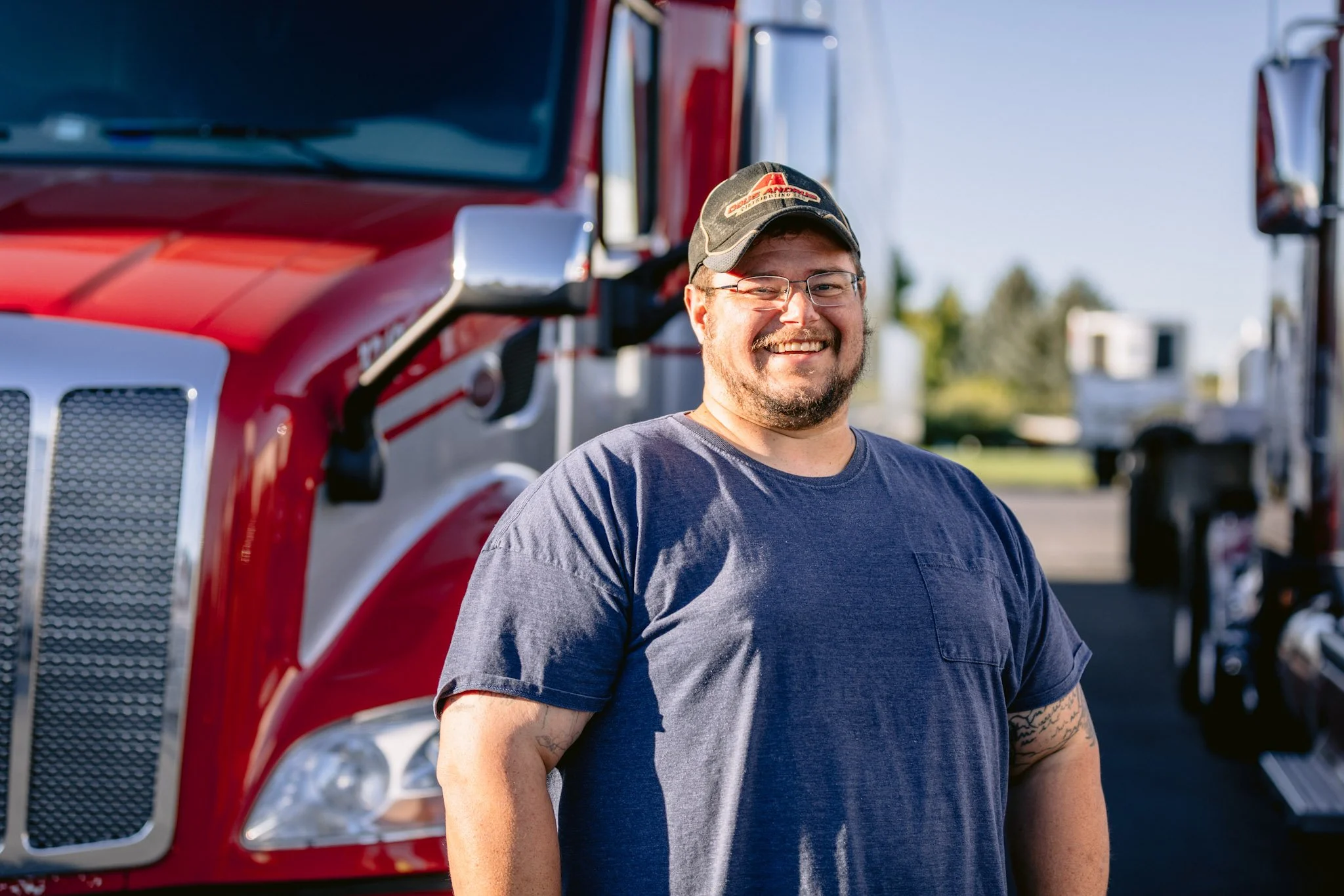 Cross-Border Driver beside a semi truck