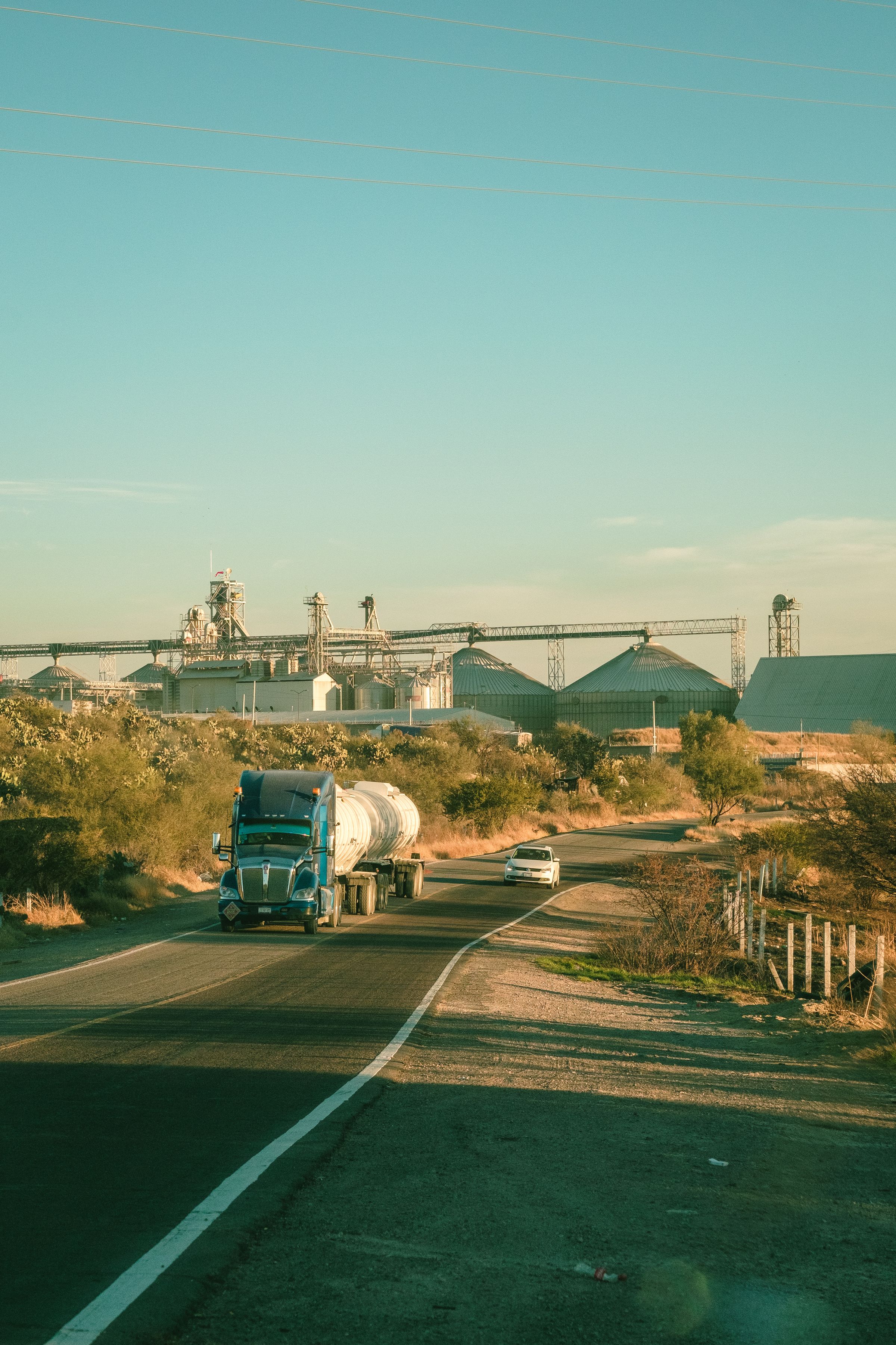 An unbranded semi truck traveling on a rural road
